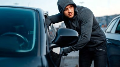 Man Breaking Into Car Window