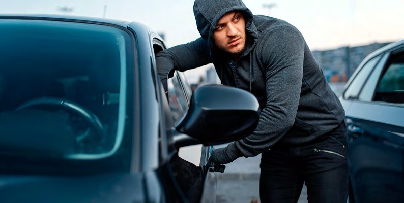 Man Breaking Into Car Window
