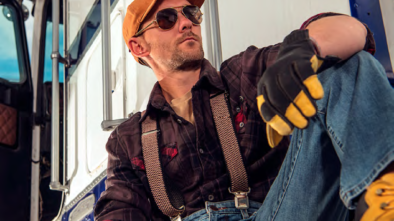 Man sitting beside truck