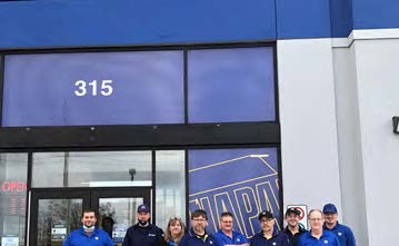 Napa employees standing in front of Napa Auto Parts