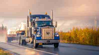 A semi-truck carrying bags.
